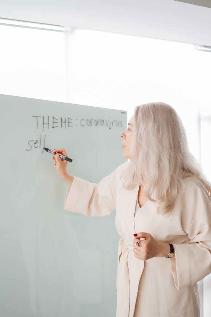 Adult woman teaching a coronavirus-related theme in an indoor classroom.